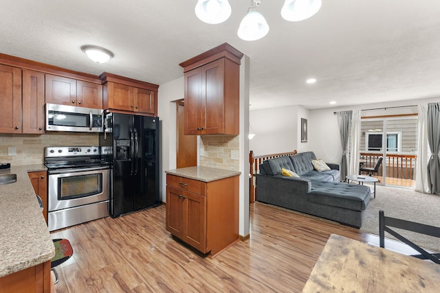 1533 Roundhouse Cir, Shakopee, MN 55379 - kitchen with appliances with stainless steel finishes, open floor plan, light wood-style floors, backsplash, and brown cabinetry