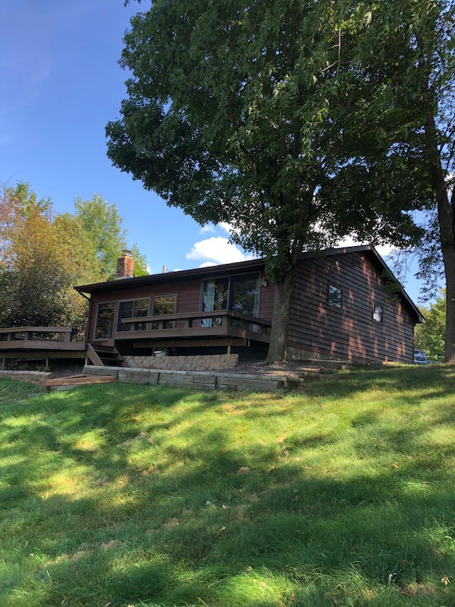43923 Vista Rd, Isle, MN 56342 - rear view of house with a wooden deck, a chimney, and a yard