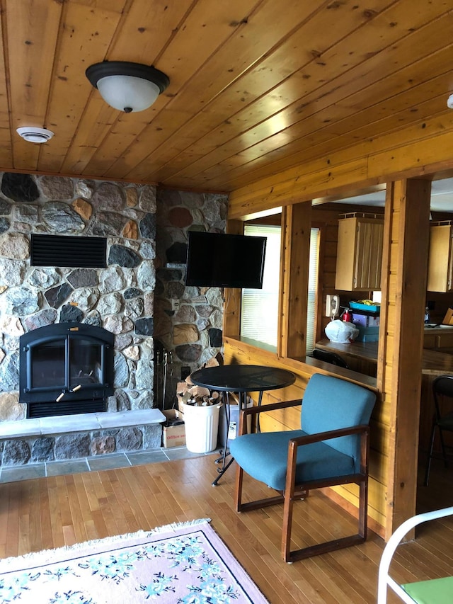 43923 Vista Rd, Isle, MN 56342 - living room featuring hardwood / wood-style flooring, wooden ceiling, and a stone fireplace