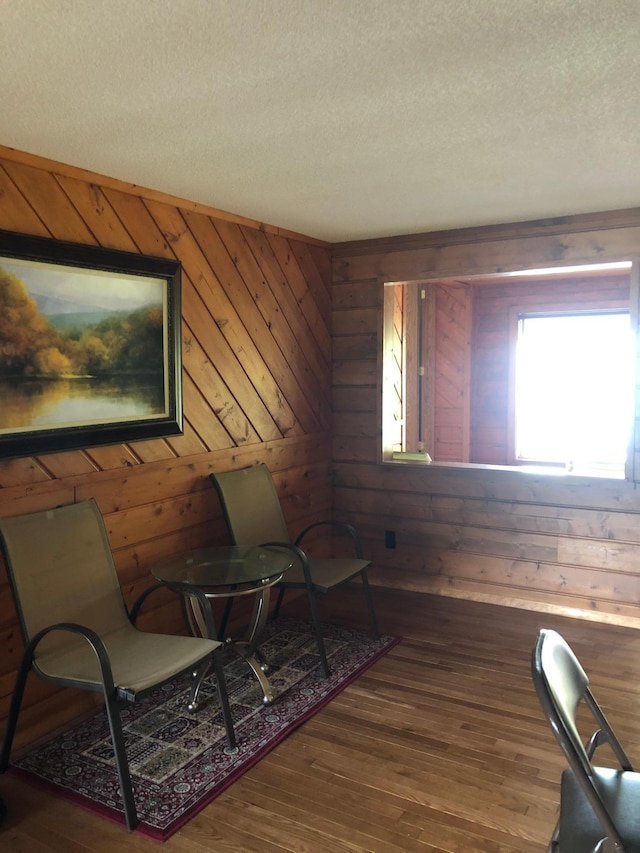 43923 Vista Rd, Isle, MN 56342 - sitting room with a textured ceiling, wood walls, and wood-type flooring