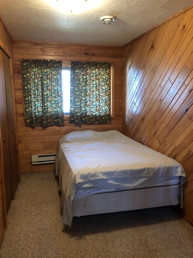 43923 Vista Rd, Isle, MN 56342 - bedroom with a baseboard radiator, wood walls, and carpet flooring
