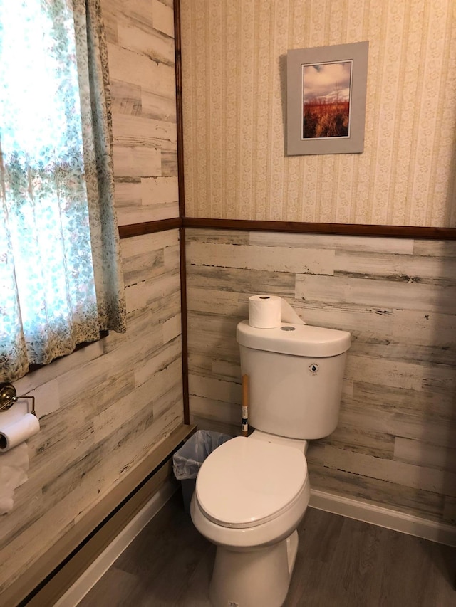43923 Vista Rd, Isle, MN 56342 - half bathroom featuring toilet, wallpapered walls, wood finished floors, wainscoting, and wooden walls
