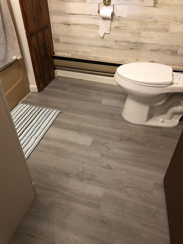 43923 Vista Rd, Isle, MN 56342 - bathroom with toilet, wood walls, and wood finished floors