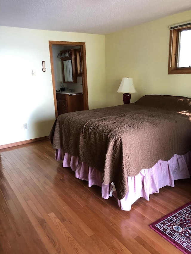 43923 Vista Rd, Isle, MN 56342 - bedroom with wood finished floors, a textured ceiling, and baseboards