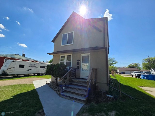 310 20th St N, Fargo, ND 58102 - view of front of house with a front yard and stucco siding