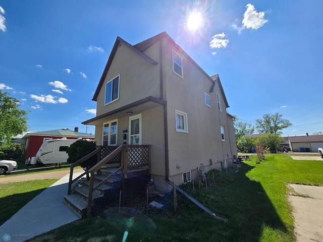 310 20th St N, Fargo, ND 58102 - view of front of property featuring a front lawn and stucco siding
