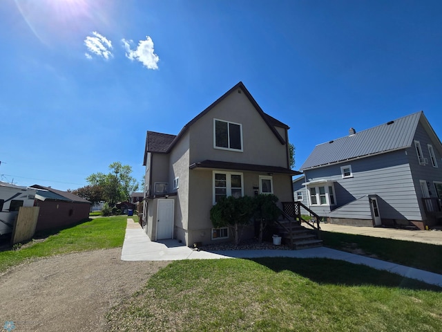 310 20th St N, Fargo, ND 58102 - back of house with stucco siding and a lawn