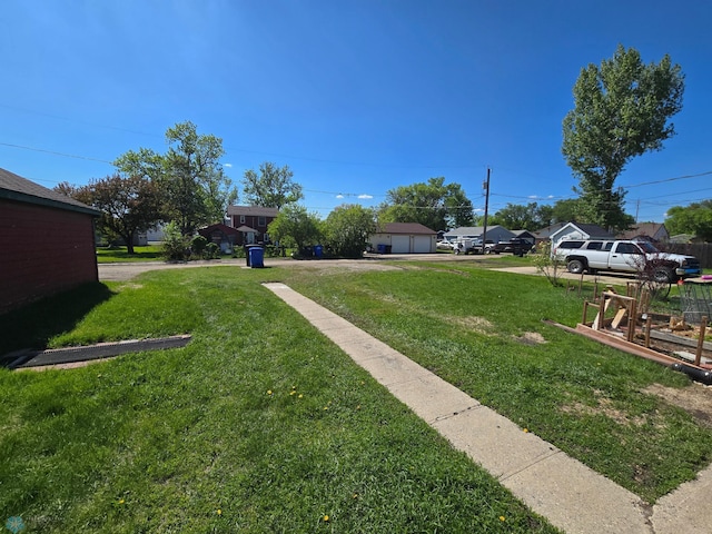 310 20th St N, Fargo, ND 58102 - view of grassy yard with a detached garage