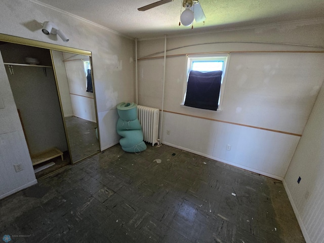 310 20th St N, Fargo, ND 58102 - unfurnished bedroom featuring radiator heating unit, baseboards, a textured ceiling, and a ceiling fan