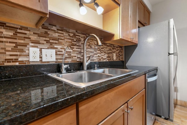 4500 Chicago Ave Unit 103, Minneapolis, MN 55407 - kitchen with a sink, stainless steel dishwasher, decorative backsplash, and dark stone counters