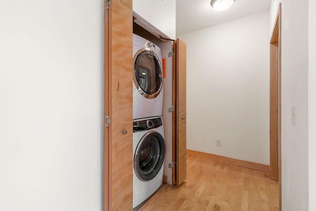 4500 Chicago Ave Unit 103, Minneapolis, MN 55407 - laundry room featuring estacked washer and dryer, light wood finished floors, and baseboards