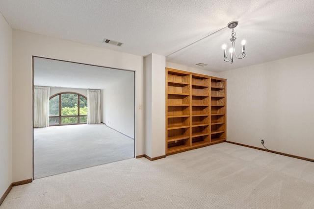 5100 France Ave S Unit 305, Edina, MN 55410 - carpeted spare room with a chandelier, a textured ceiling, and baseboards