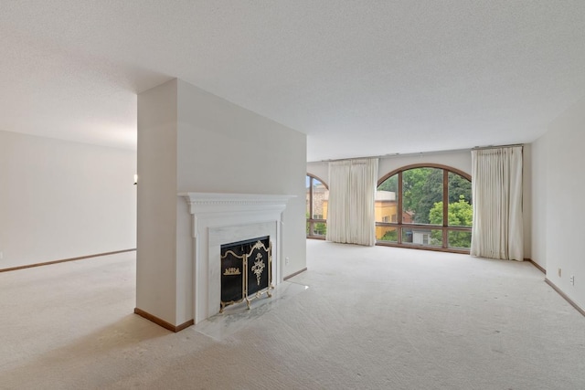 5100 France Ave S Unit 305, Edina, MN 55410 - unfurnished living room with carpet, baseboards, a textured ceiling, and a fireplace with flush hearth