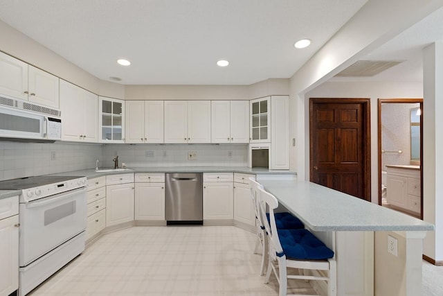 5100 France Ave S Unit 305, Edina, MN 55410 - kitchen with white appliances, light flooring, light countertops, backsplash, and recessed lighting