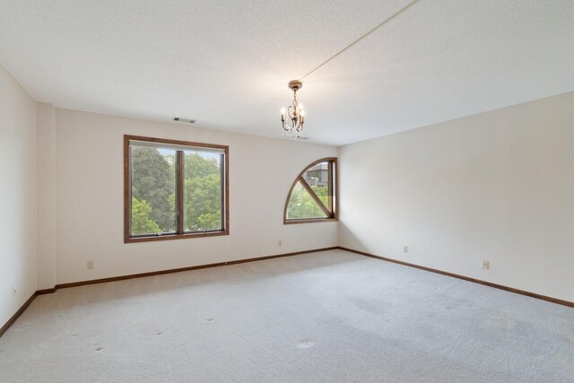 5100 France Ave S Unit 305, Edina, MN 55410 - unfurnished room featuring a chandelier, plenty of natural light, light colored carpet, and baseboards