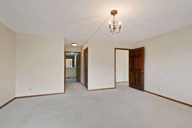 5100 France Ave S Unit 305, Edina, MN 55410 - spare room with light carpet, a chandelier, and baseboards