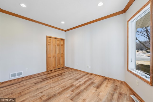 20595 Kearney Path, Lakeville, MN 55044 - unfurnished room with plenty of natural light, ornamental molding, wood finished floors, baseboards, and recessed lighting