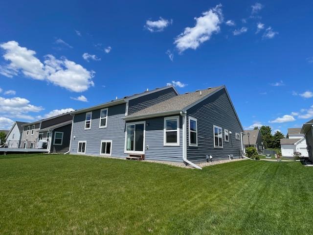 18053 Gleaming Ct, Lakeville, MN 55044 - rear view of property featuring entry steps and a lawn