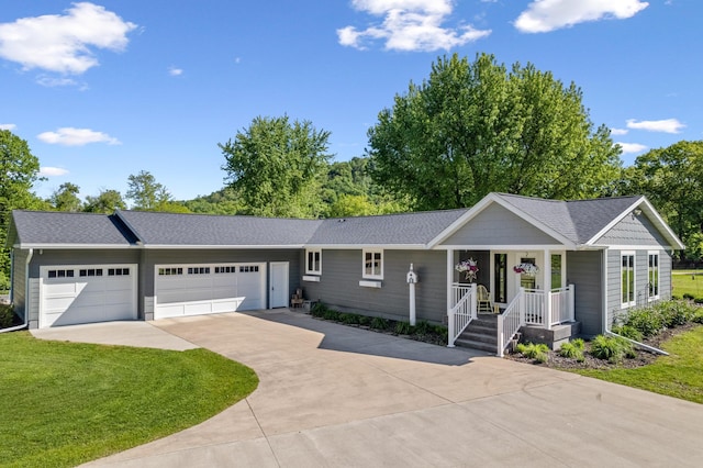 W770 Meadow Ln, Fountain City, WI 54629 - ranch-style home with driveway, a garage, a front yard, and a shingled roof