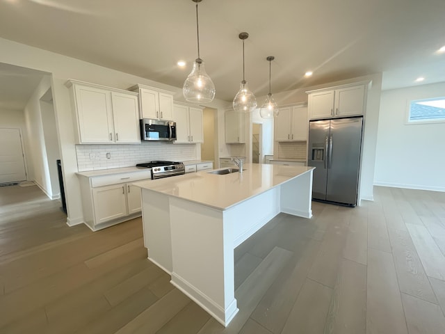9729 49th St NE, Saint Michael, MN 55376 - kitchen featuring stainless steel appliances, a sink, tasteful backsplash, white cabinetry, and recessed lighting