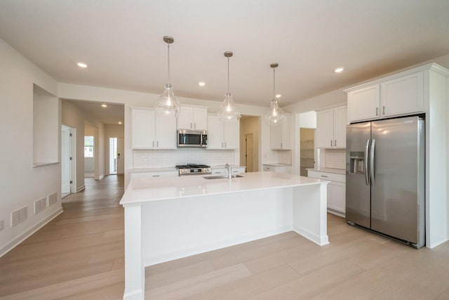 9729 49th St NE, Saint Michael, MN 55376 - kitchen with stainless steel appliances, light wood-type flooring, tasteful backsplash, recessed lighting, and light countertops