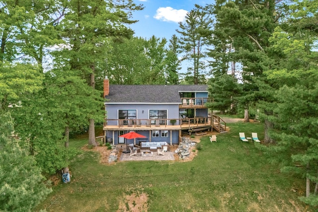 2625 7th Ave, Chetek, WI 54728 - rear view of property featuring a patio area, a wooden deck, a chimney, a lawn, and an outdoor hangout area