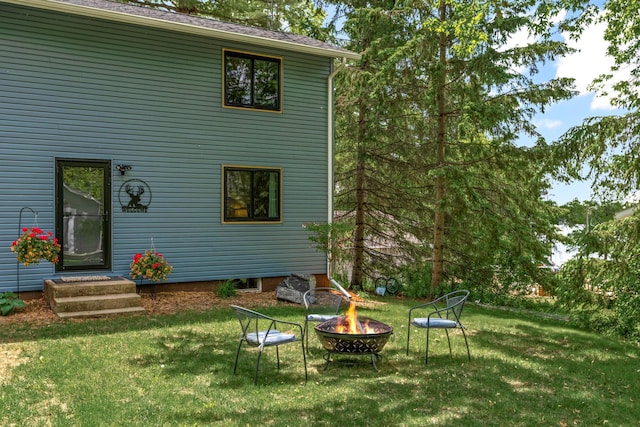 2625 7th Ave, Chetek, WI 54728 - back of house featuring an outdoor fire pit and a lawn