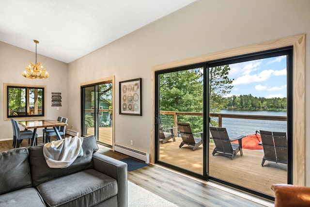 2625 7th Ave, Chetek, WI 54728 - living area with wood finished floors, a chandelier, a baseboard radiator, vaulted ceiling, and a water view