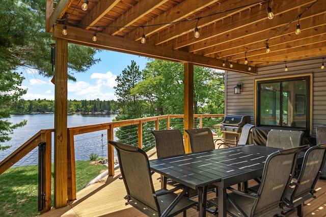 2625 7th Ave, Chetek, WI 54728 - wooden terrace featuring a water view, outdoor dining space, and grilling area