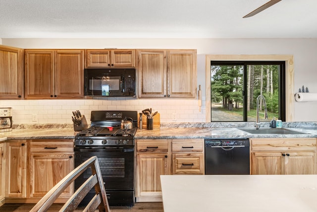 2625 7th Ave, Chetek, WI 54728 - kitchen featuring black appliances, a sink, wood finished floors, and tasteful backsplash