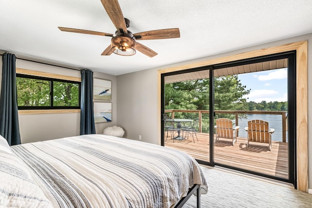 2625 7th Ave, Chetek, WI 54728 - bedroom featuring access to outside, multiple windows, a water view, and a ceiling fan
