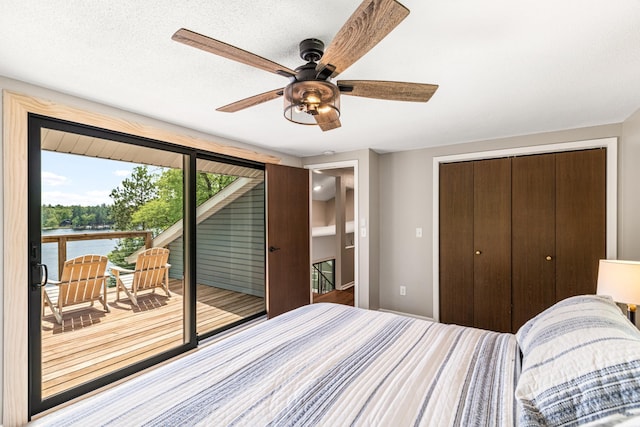 2625 7th Ave, Chetek, WI 54728 - bedroom featuring access to exterior, a closet, a ceiling fan, and a water view