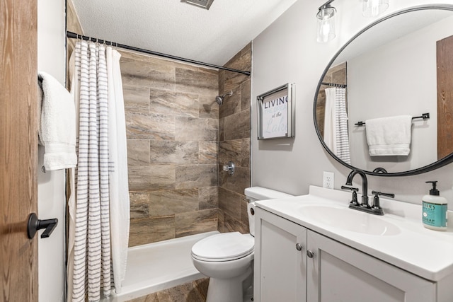 2625 7th Ave, Chetek, WI 54728 - full bathroom with toilet, vanity, tiled shower, a textured ceiling, and wood finished floors