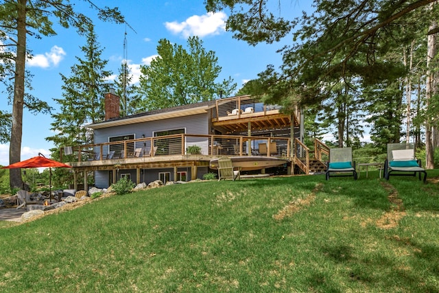 2625 7th Ave, Chetek, WI 54728 - rear view of house featuring a deck, a chimney, and a lawn