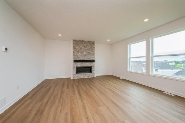 535 Rolling Hills Ln, Delano, MN 55328 - unfurnished living room with light wood finished floors, a fireplace, and recessed lighting