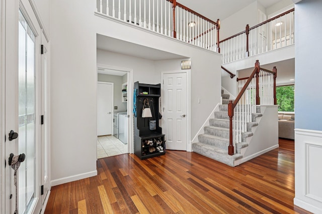 14075 45th Ct NE, Saint Michael, MN 55376 - entryway featuring independent washer and dryer, stairs, wood finished floors, a high ceiling, and baseboards