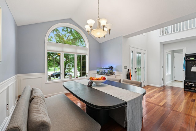 14075 45th Ct NE, Saint Michael, MN 55376 - dining room with a chandelier, a wainscoted wall, wood finished floors, high vaulted ceiling, and french doors