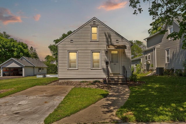 624 2nd St NE, Faribault, MN 55021 - view of front of house with central AC unit, a front lawn, and entry steps