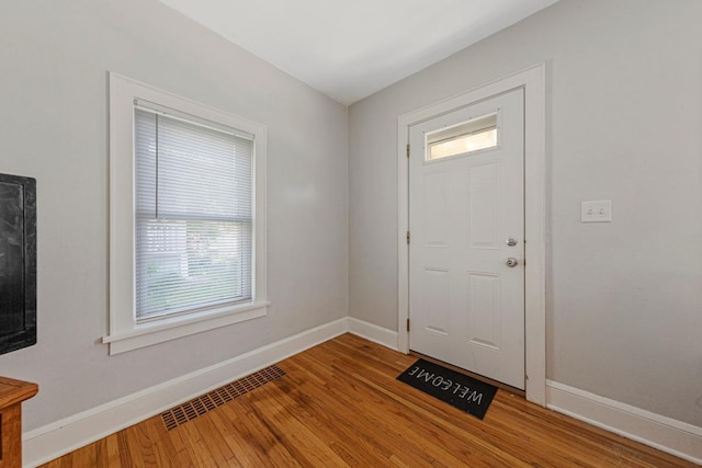 624 2nd St NE, Faribault, MN 55021 - entryway featuring baseboards, healthy amount of natural light, and wood finished floors