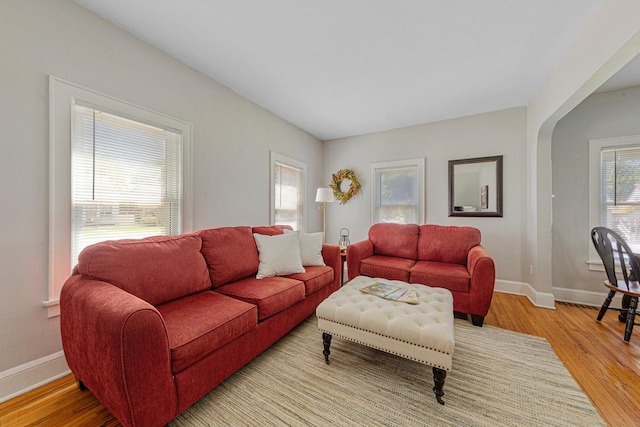624 2nd St NE, Faribault, MN 55021 - living area with baseboards, light wood-type flooring, and arched walkways