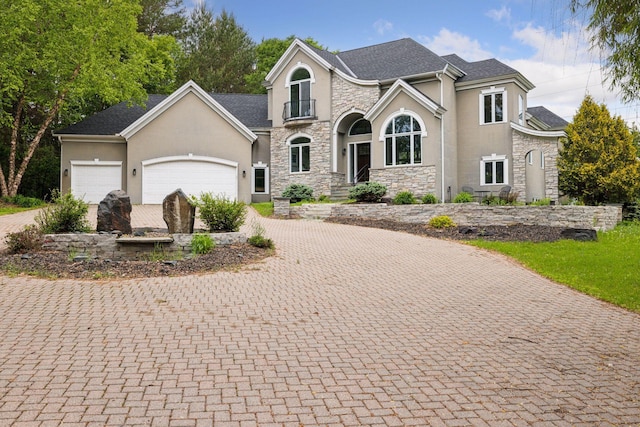 17032 Valley Dr NW, Andover, MN 55304 - view of front of property with stone siding, stucco siding, decorative driveway, and an attached garage