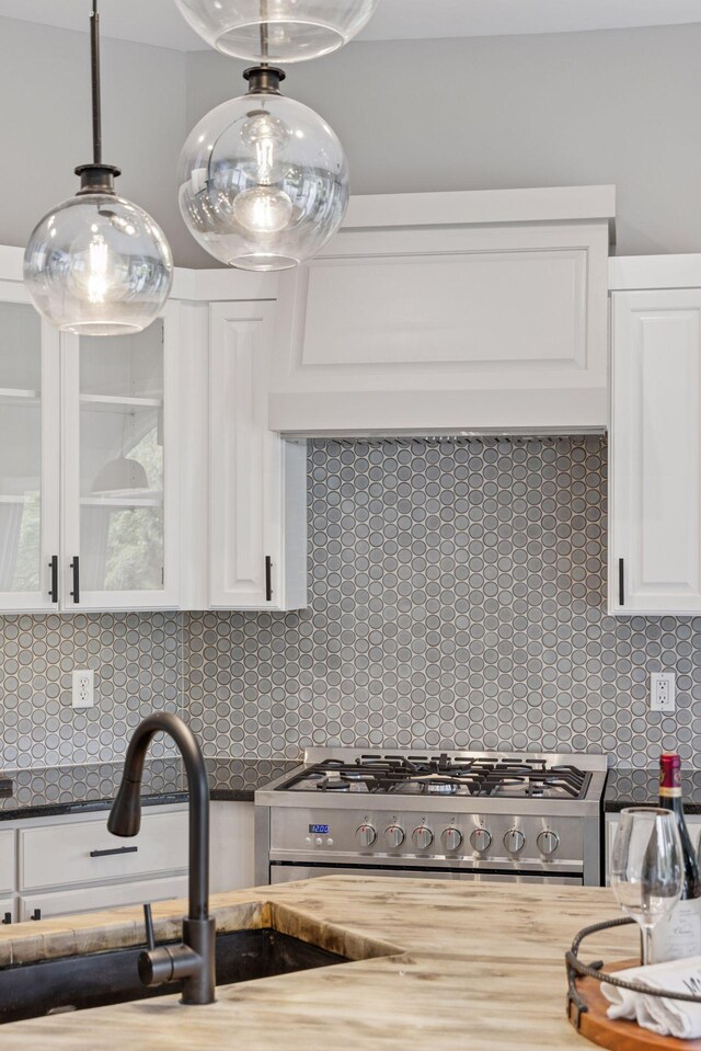 17032 Valley Dr NW, Andover, MN 55304 - kitchen with a sink, backsplash, white cabinets, glass insert cabinets, and stainless steel range with gas cooktop