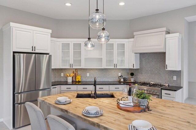 17032 Valley Dr NW, Andover, MN 55304 - kitchen featuring appliances with stainless steel finishes, wooden counters, a sink, custom exhaust hood, and pendant lighting