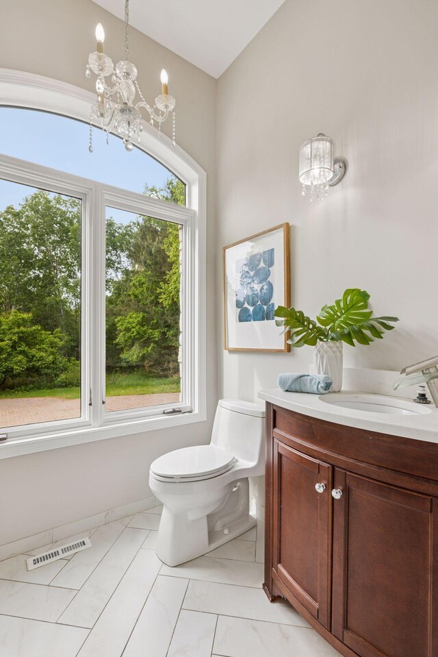 17032 Valley Dr NW, Andover, MN 55304 - half bath with a chandelier, toilet, and vanity