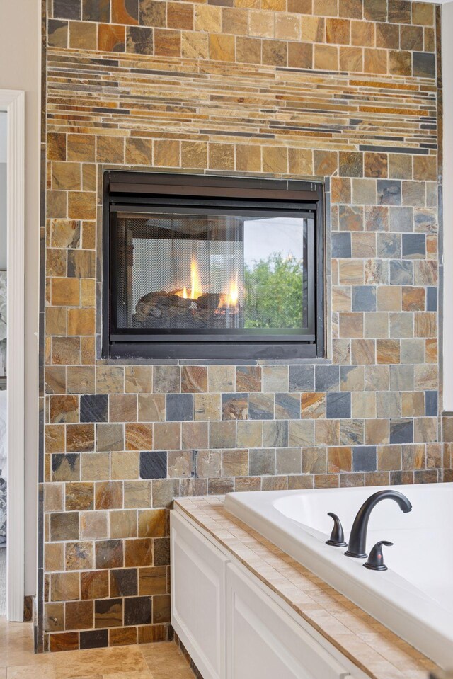 17032 Valley Dr NW, Andover, MN 55304 - detailed view of a garden tub and a warm lit fireplace