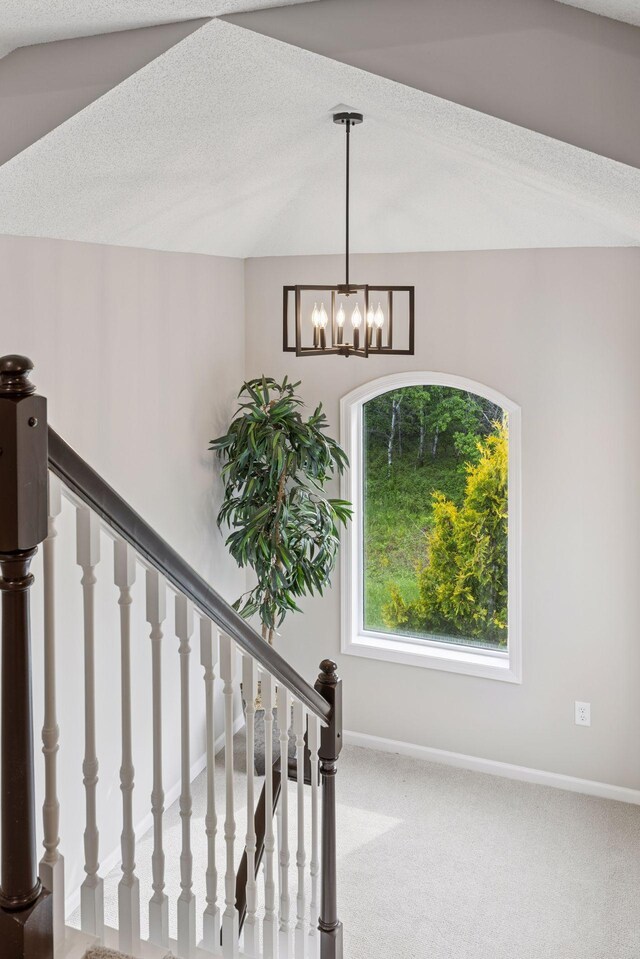 17032 Valley Dr NW, Andover, MN 55304 - stairs featuring a chandelier, baseboards, and carpet floors