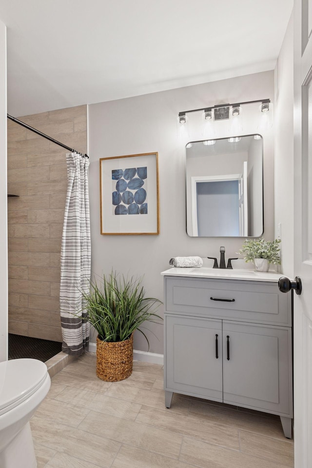 17032 Valley Dr NW, Andover, MN 55304 - full bath featuring vanity, toilet, a tile shower, and baseboards