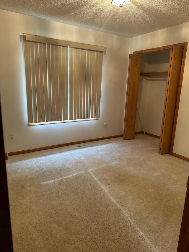 6501 Douglas Dr N, Brooklyn Park, MN 55429 - unfurnished bedroom featuring carpet, a textured ceiling, and a closet