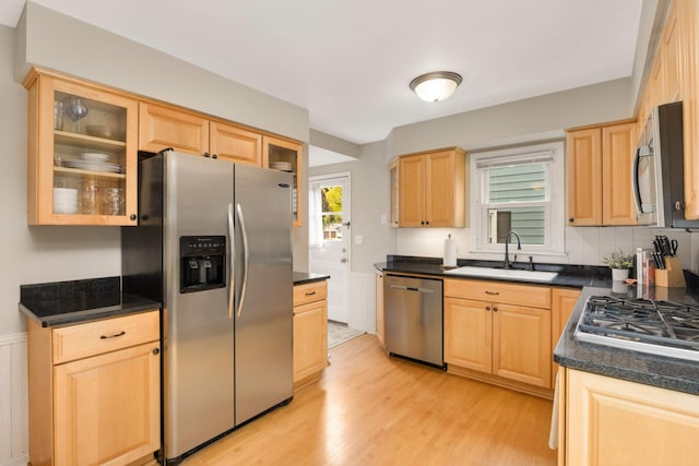 3350 Virginia Ave S, Saint Louis Park, MN 55426 - kitchen featuring appliances with stainless steel finishes, a sink, light brown cabinetry, light wood-type flooring, and dark countertops