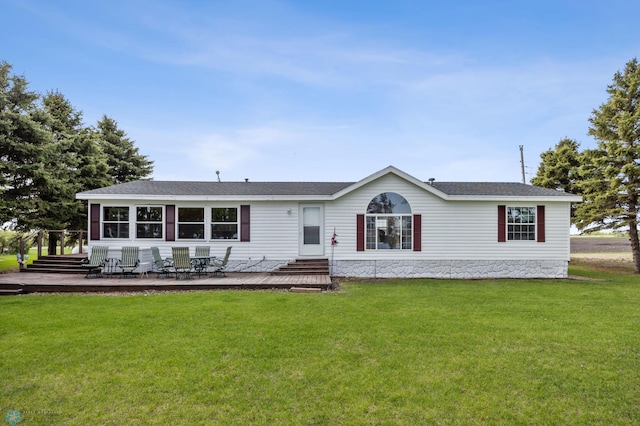 3022 Sandy Beach Rd, Hatton, ND 58240 - view of front of home featuring a front yard, a shingled roof, and a wooden deck